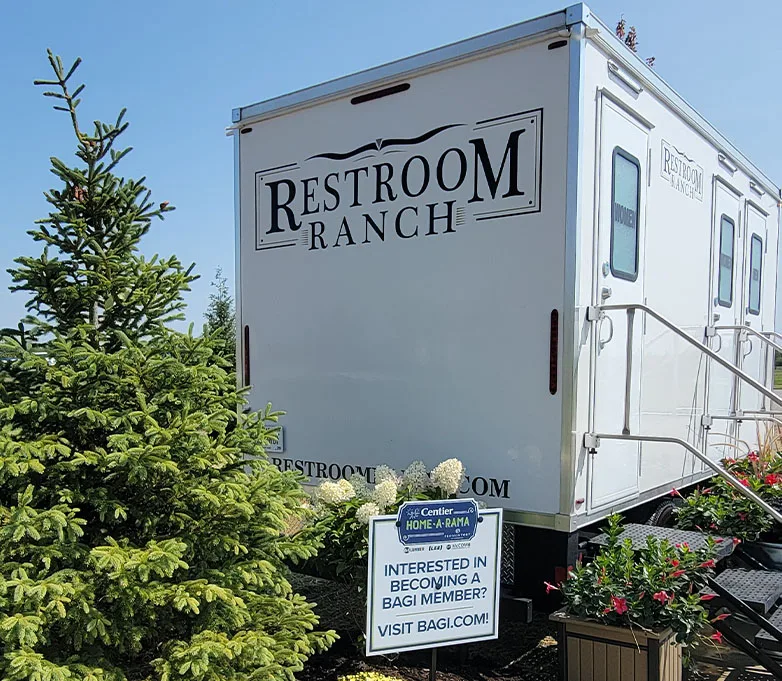 Exterior of a Restroom Ranch trailer with planters and steps