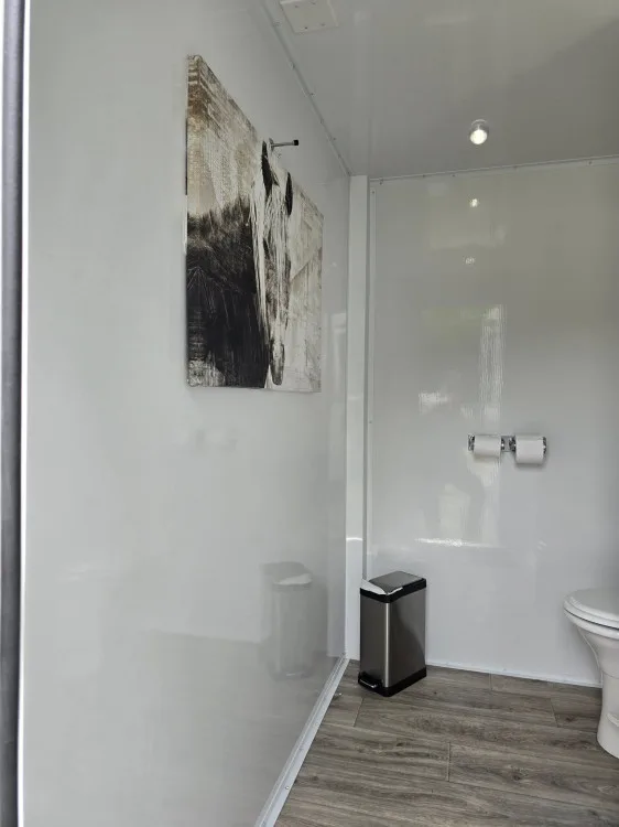 Women's suite interior with vanity, mirror and tile detailing
