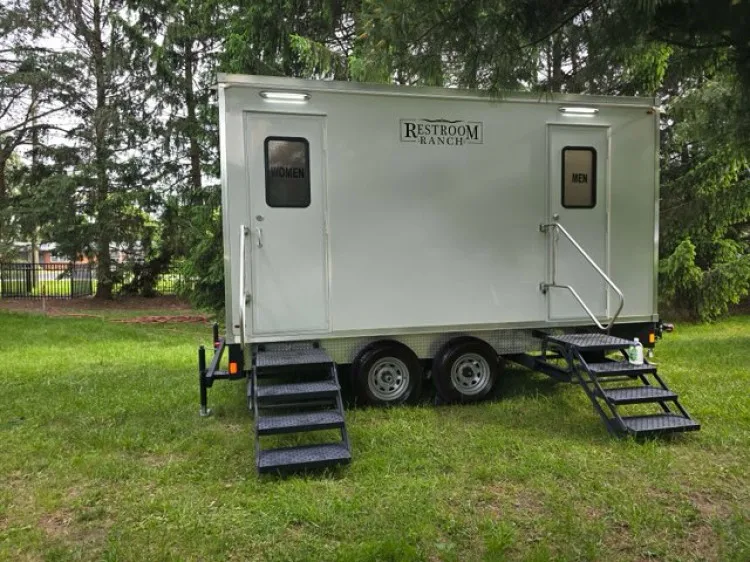 2-station luxury restroom trailer with separate women's and men's doors on grass