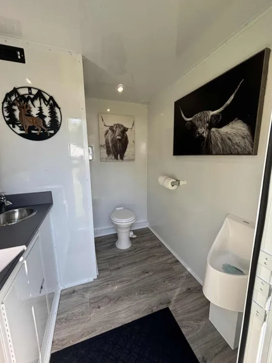 Interior of the Restroom Ranch 2-station luxury restroom trailer with porcelain fixtures and ranch artwork